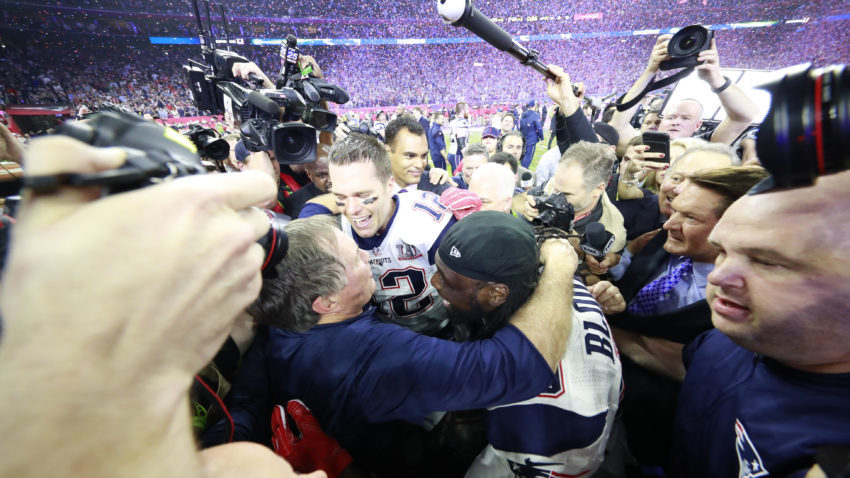 Bill Belichick, the head coach of the New England Patriots, embraces quarterback Tom Brady (12) and running back LeGarrette Blount (29) after winning Super Bowl LI at the NRG Stadium in Houston, Feb. 5, 2017. (Doug Mills/The New York Times)